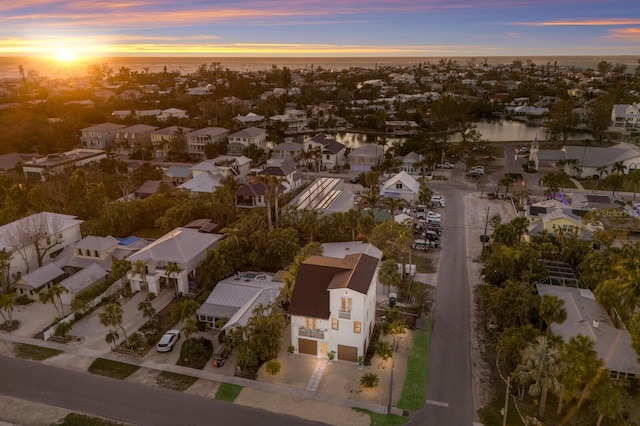 drone / aerial view with a residential view and a water view