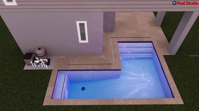 view of swimming pool with a yard