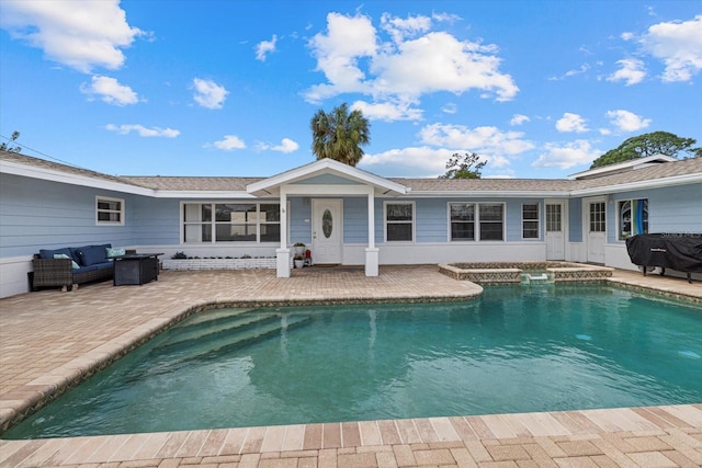 back of house with a patio area and an outdoor pool