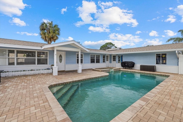 pool featuring a patio area and grilling area