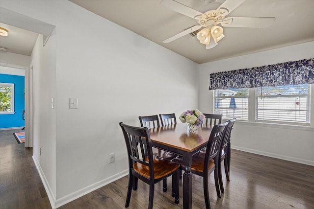 dining area featuring baseboards, ceiling fan, wood finished floors, and a healthy amount of sunlight