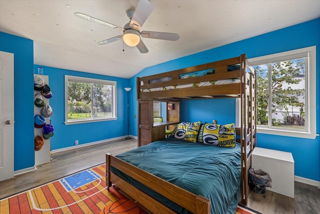 bedroom with vaulted ceiling, ceiling fan, wood finished floors, and baseboards