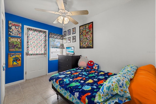 bedroom featuring ceiling fan, baseboards, and light tile patterned floors