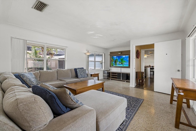 living room with visible vents and speckled floor