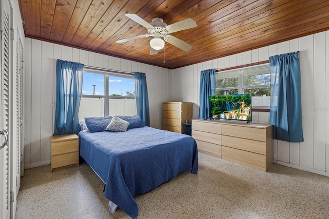 bedroom featuring speckled floor, wood ceiling, and a ceiling fan