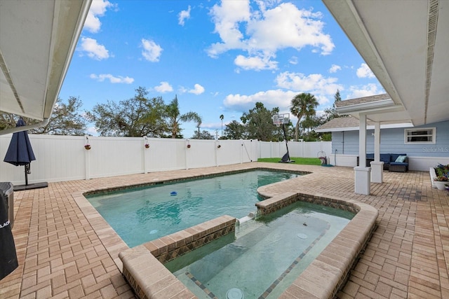 view of swimming pool with a patio, a fenced backyard, and a pool with connected hot tub