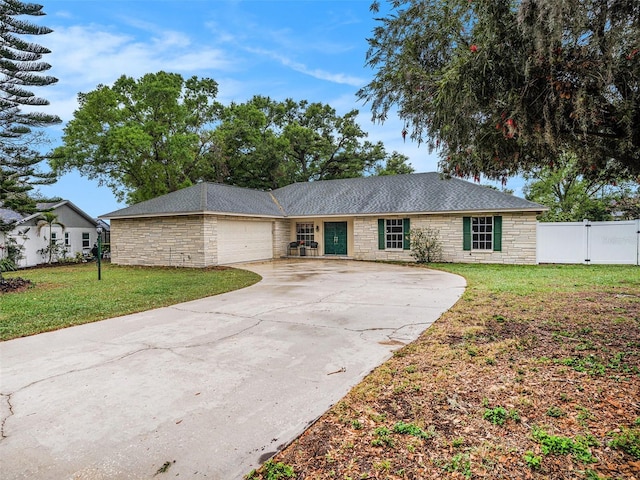 single story home with a garage, stone siding, and a front yard