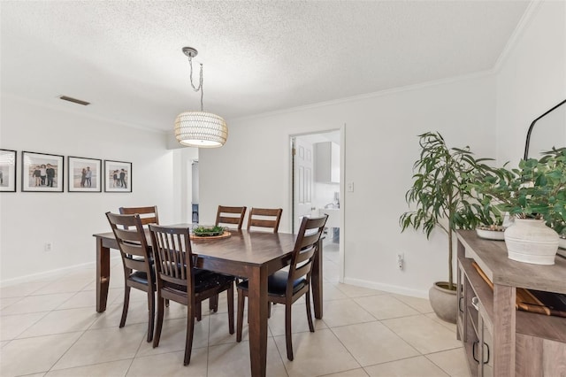 dining room featuring light tile patterned floors, baseboards, a textured ceiling, and crown molding