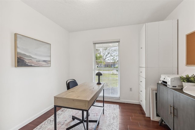 office area with dark wood-type flooring and baseboards