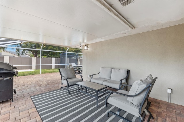 view of patio / terrace featuring visible vents, an outdoor living space, fence, grilling area, and glass enclosure