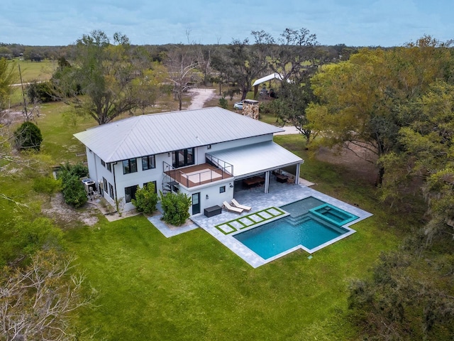 drone / aerial view with a wooded view