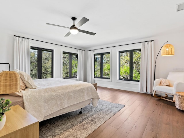 bedroom featuring a ceiling fan, visible vents, and hardwood / wood-style floors