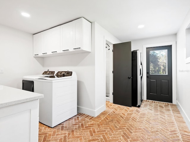 washroom featuring cabinet space, baseboards, independent washer and dryer, brick floor, and recessed lighting