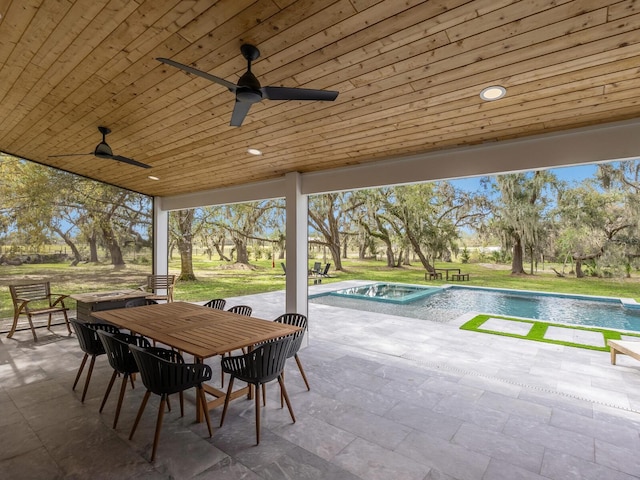 view of patio featuring outdoor dining area, an outdoor pool, a jacuzzi, and a ceiling fan