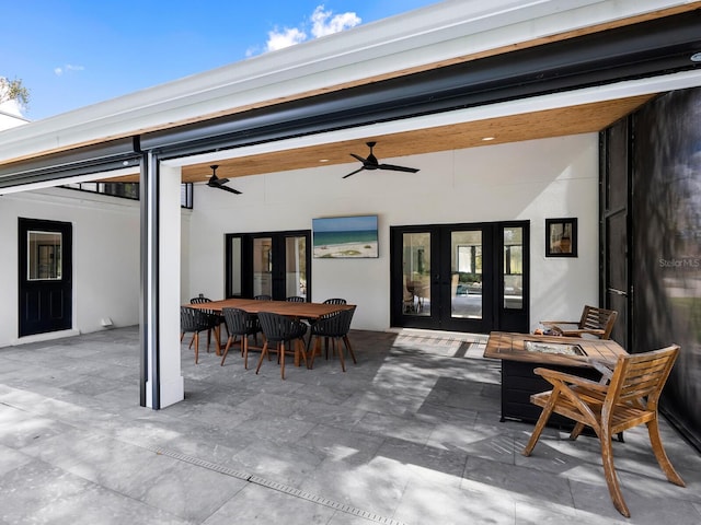 rear view of property featuring a ceiling fan, outdoor dining area, french doors, a patio area, and stucco siding