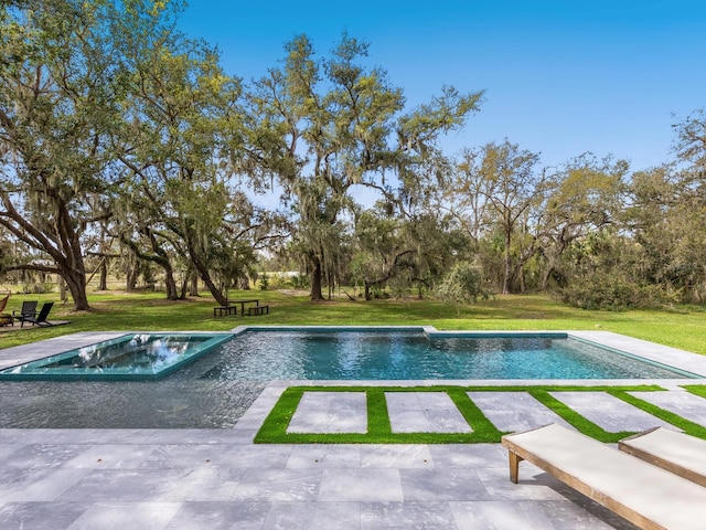 outdoor pool with a yard, a patio, and an in ground hot tub