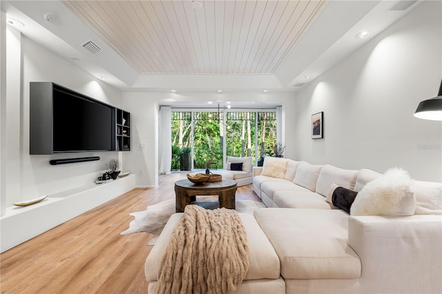 living area featuring a tray ceiling, light wood finished floors, recessed lighting, visible vents, and wood ceiling