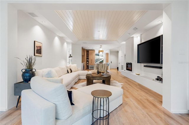 living room featuring wood ceiling, visible vents, and light wood finished floors