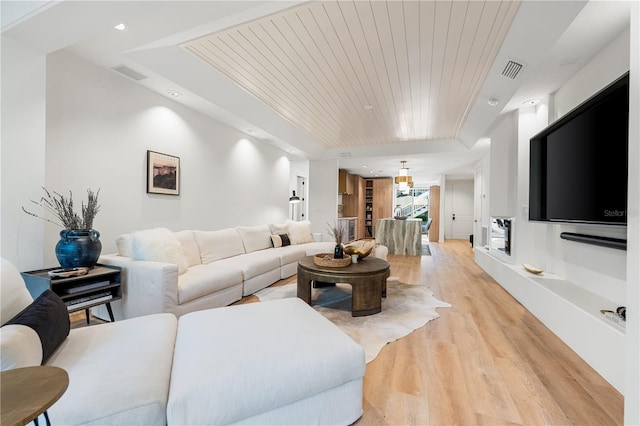 living area with light wood finished floors, wooden ceiling, visible vents, and recessed lighting