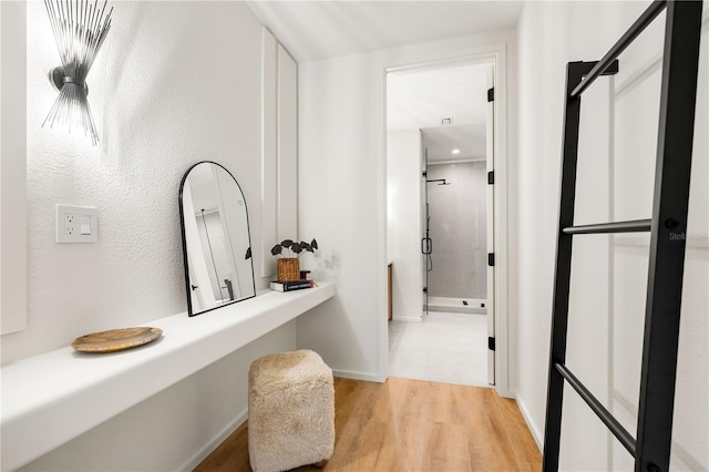 bathroom featuring wood finished floors and baseboards