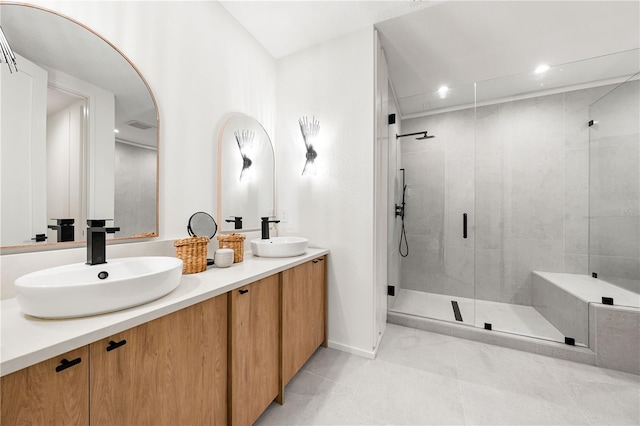 full bathroom featuring double vanity, recessed lighting, a sink, and a shower stall