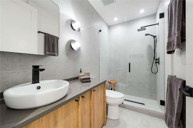 bathroom with a stall shower, visible vents, tile walls, toilet, and backsplash