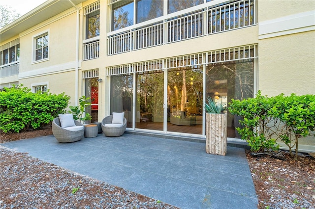 property entrance with a patio and stucco siding