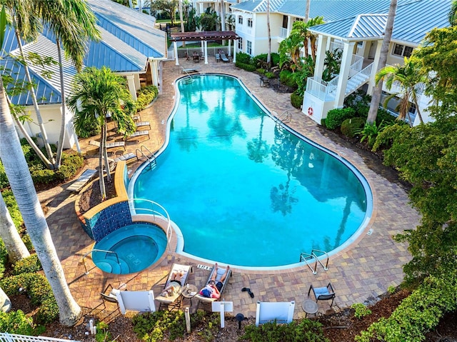 pool featuring a patio and a hot tub