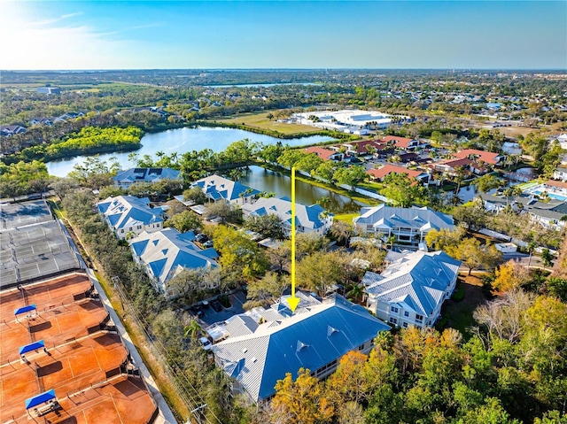 drone / aerial view featuring a water view and a residential view