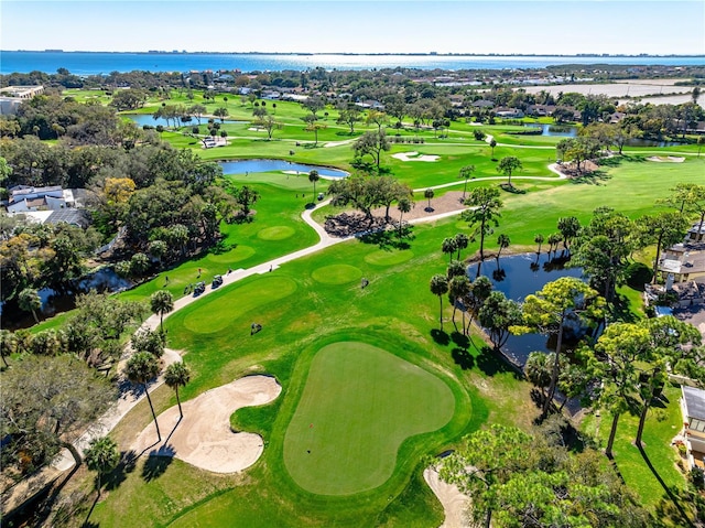 aerial view with golf course view and a water view