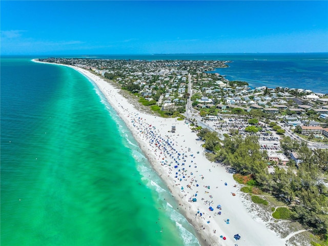 drone / aerial view featuring a beach view and a water view