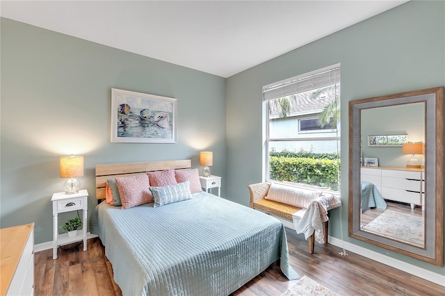 bedroom featuring baseboards and wood finished floors