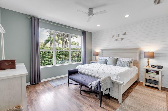 bedroom with visible vents, ceiling fan, baseboards, and wood finished floors