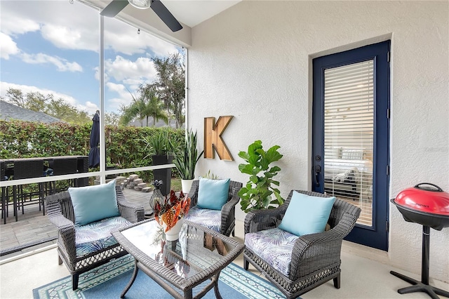 sunroom featuring ceiling fan