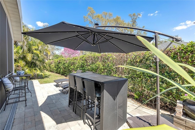 view of patio / terrace featuring outdoor dry bar and outdoor dining area