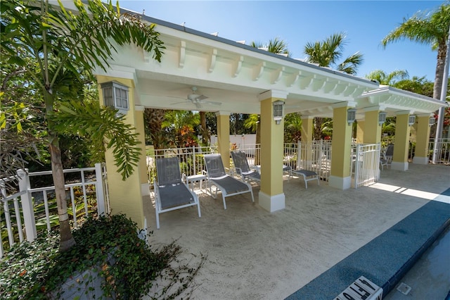 view of patio featuring ceiling fan, fence, and a gazebo