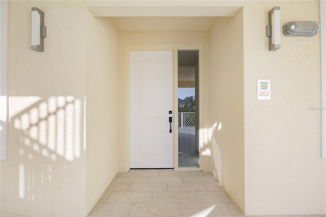 view of exterior entry featuring stucco siding