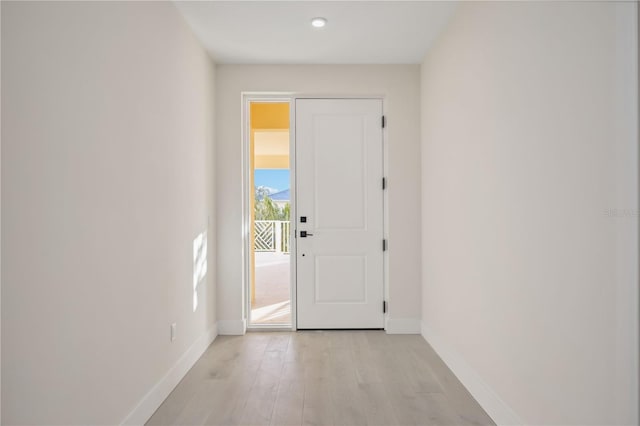 entrance foyer with light wood-type flooring and baseboards