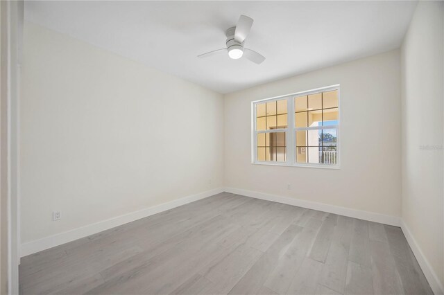 unfurnished room featuring ceiling fan, baseboards, and wood finished floors