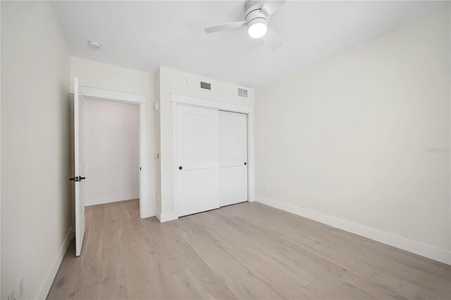 unfurnished bedroom with visible vents, baseboards, a closet, and light wood finished floors