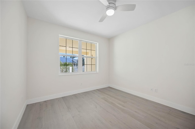 unfurnished room with ceiling fan, baseboards, and wood finished floors