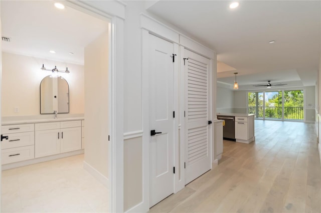 280 Hidden Bay Dr Unit 202, Osprey, FL 34229 - hallway with recessed lighting, a sink, light wood-type flooring, and baseboards