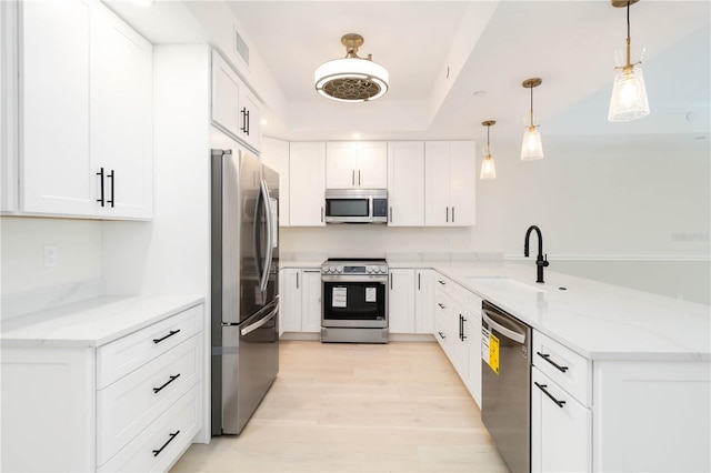 280 Hidden Bay Dr Unit 202, Osprey, FL 34229 - kitchen featuring stainless steel appliances, a sink, a peninsula, light stone counters, and recessed lighting