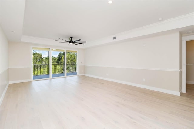 280 Hidden Bay Dr Unit 202, Osprey, FL 34229 - unfurnished room with baseboards, light wood-style flooring, a tray ceiling, ceiling fan, and ornamental molding