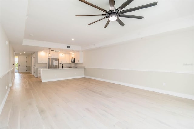 280 Hidden Bay Dr Unit 202, Osprey, FL 34229 - unfurnished living room featuring light wood finished floors, a ceiling fan, baseboards, a sink, and recessed lighting