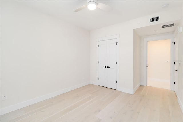 280 Hidden Bay Dr Unit 202, Osprey, FL 34229 - unfurnished bedroom with light wood-style floors, baseboards, a closet, and a ceiling fan