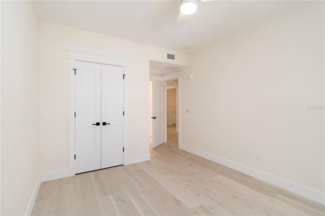 280 Hidden Bay Dr Unit 202, Osprey, FL 34229 - unfurnished bedroom featuring light wood-type flooring, baseboards, a ceiling fan, and a closet