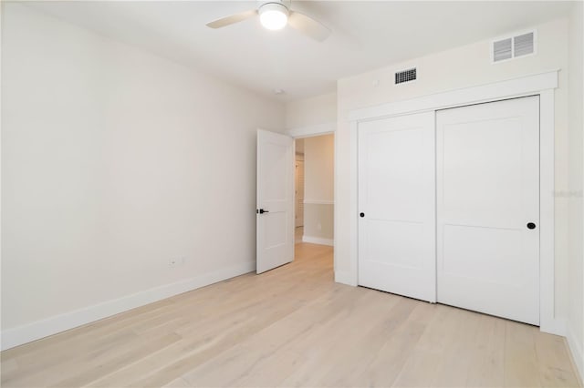 280 Hidden Bay Dr Unit 202, Osprey, FL 34229 - unfurnished bedroom with light wood-style floors, baseboards, a closet, and ceiling fan