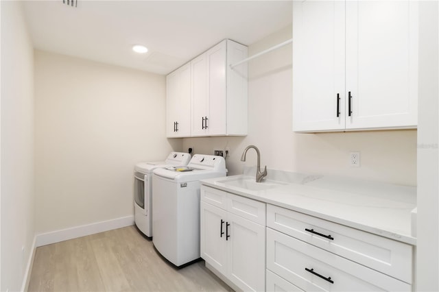 280 Hidden Bay Dr Unit 202, Osprey, FL 34229 - clothes washing area featuring cabinet space, separate washer and dryer, light wood finished floors, baseboards, and recessed lighting