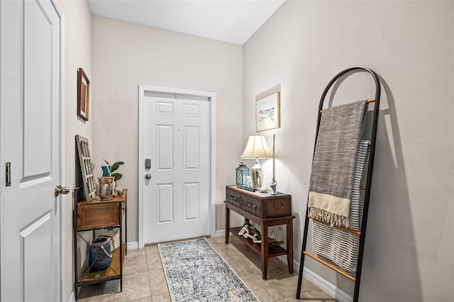entryway with light tile patterned floors and baseboards